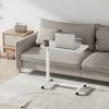 Aura Lite Spring Assisted Height Adjustable Over-bed Table in White sofa scene