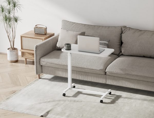 Aura Lite Spring Assisted Height Adjustable Over-bed Table in White sofa scene